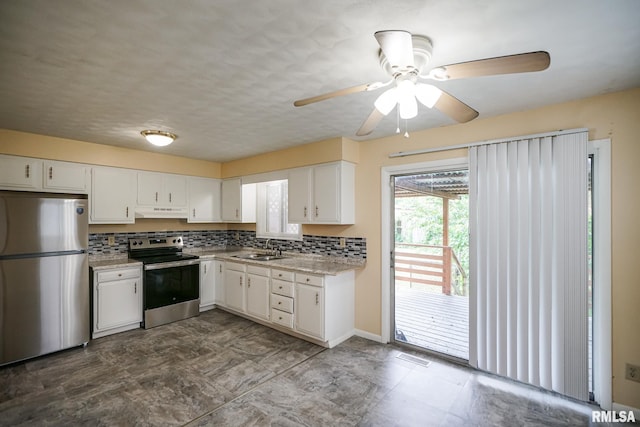 2705 W Millbrook Ct, Peoria, IL 61615 - kitchen with appliances with stainless steel finishes, under cabinet range hood, white cabinets, ceiling fan, and backsplash