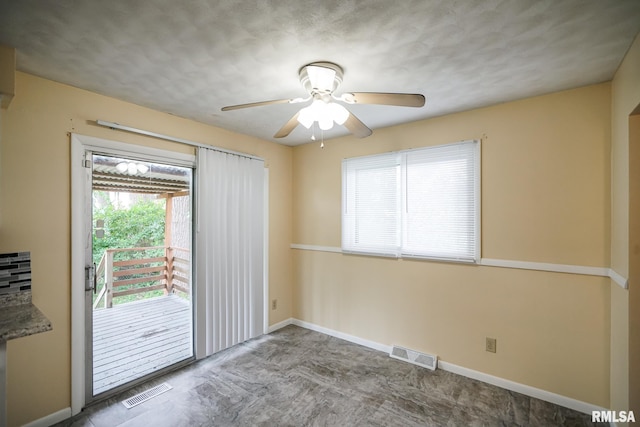 2705 W Millbrook Ct, Peoria, IL 61615 - spare room featuring a ceiling fan and baseboards