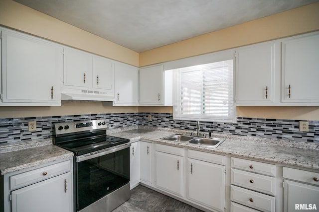 2705 W Millbrook Ct, Peoria, IL 61615 - kitchen with stainless steel range with electric stovetop, under cabinet range hood, light countertops, backsplash, and white cabinetry