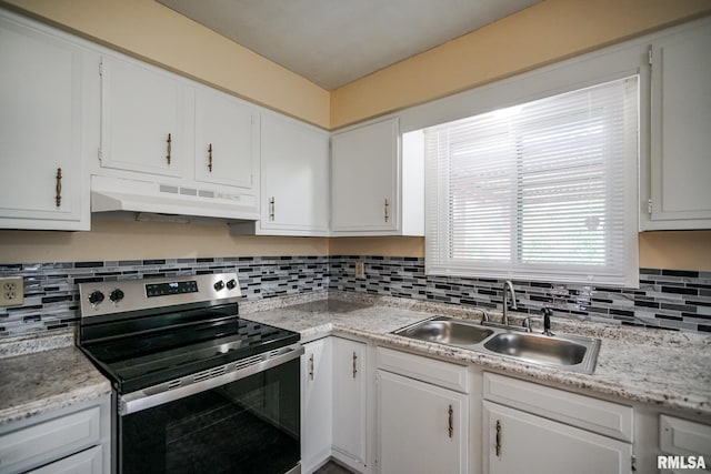 2705 W Millbrook Ct, Peoria, IL 61615 - kitchen with stainless steel electric range oven, under cabinet range hood, light countertops, white cabinets, and decorative backsplash