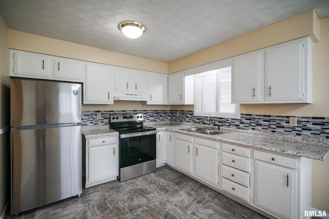 2705 W Millbrook Ct, Peoria, IL 61615 - kitchen with stainless steel appliances, under cabinet range hood, white cabinets, light countertops, and decorative backsplash