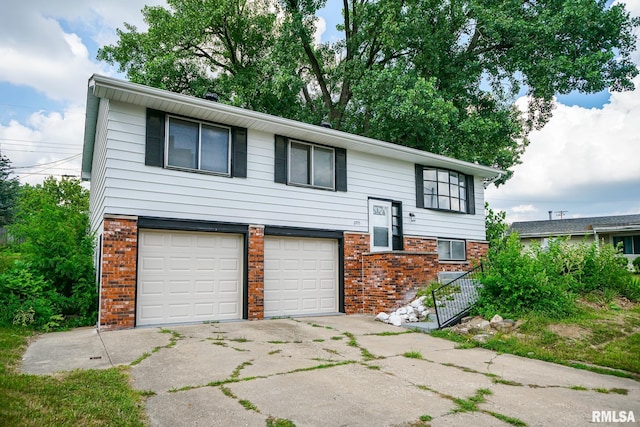 2705 W Millbrook Ct, Peoria, IL 61615 - raised ranch featuring brick siding, a garage, and concrete driveway