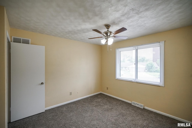 2705 W Millbrook Ct, Peoria, IL 61615 - unfurnished room with ceiling fan, dark carpet, and a textured ceiling