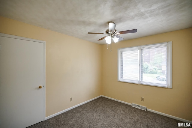 2705 W Millbrook Ct, Peoria, IL 61615 - spare room with dark colored carpet and a ceiling fan