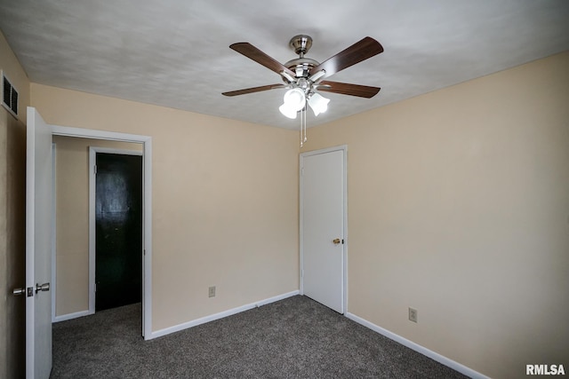 2705 W Millbrook Ct, Peoria, IL 61615 - unfurnished bedroom featuring dark colored carpet and a ceiling fan