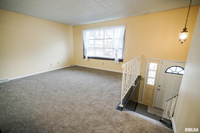 2705 W Millbrook Ct, Peoria, IL 61615 - foyer featuring dark colored carpet, healthy amount of natural light, and stairway