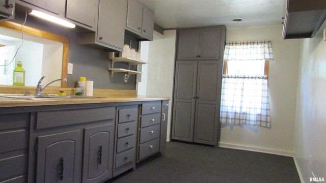728 Hanna Dr, Pekin, IL 61554 - kitchen featuring gray cabinets, light countertops, open shelves, and dark colored carpet