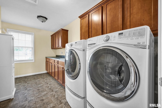 1129 Stonelake Ct, Metamora, IL 61548 - laundry area with cabinet space, washing machine and dryer, and stone finish floors
