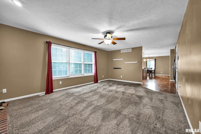 1129 Stonelake Ct, Metamora, IL 61548 - empty room featuring carpet, ceiling fan, a textured ceiling, and a chandelier
