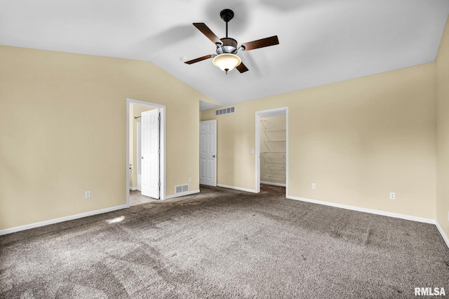 1129 Stonelake Ct, Metamora, IL 61548 - unfurnished bedroom with vaulted ceiling, carpet, a walk in closet, and ceiling fan