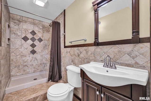 1129 Stonelake Ct, Metamora, IL 61548 - bathroom with a tile shower, vanity, tile walls, and wainscoting