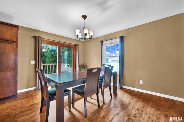 1129 Stonelake Ct, Metamora, IL 61548 - dining space featuring a chandelier, plenty of natural light, and wood finished floors