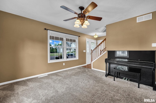 1129 Stonelake Ct, Metamora, IL 61548 - living area with stairway, carpet flooring, and a ceiling fan