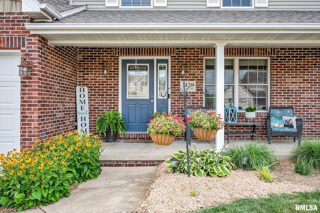 1129 Stonelake Ct, Metamora, IL 61548 - doorway to property with a porch, a shingled roof, and brick siding