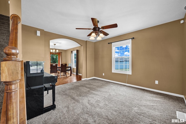 1129 Stonelake Ct, Metamora, IL 61548 - carpeted empty room featuring arched walkways, healthy amount of natural light, ceiling fan, and a chandelier