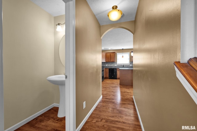 1129 Stonelake Ct, Metamora, IL 61548 - corridor featuring arched walkways and dark wood-style flooring