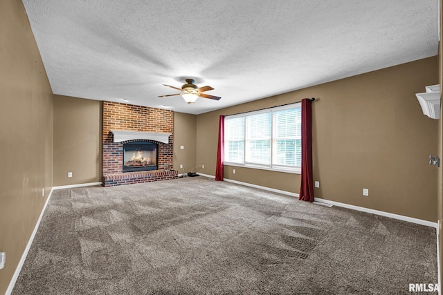 1129 Stonelake Ct, Metamora, IL 61548 - unfurnished living room with a ceiling fan, a textured ceiling, carpet flooring, and a brick fireplace