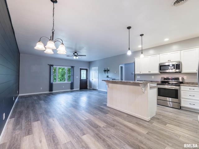 797 State Route 29th Hwy, Sparland, IL 61565 - kitchen with appliances with stainless steel finishes, a chandelier, light wood-style floors, a kitchen bar, and recessed lighting