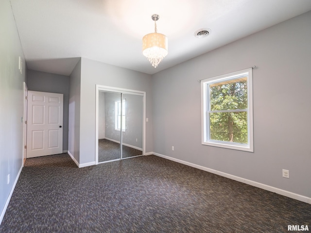 797 State Route 29th Hwy, Sparland, IL 61565 - unfurnished bedroom featuring multiple windows, carpet floors, a closet, and a chandelier