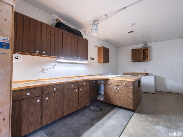 797 State Route 29th Hwy, Sparland, IL 61565 - kitchen with concrete floors, butcher block counters, fridge, and dark brown cabinets