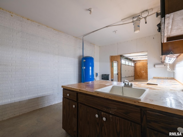 797 State Route 29th Hwy, Sparland, IL 61565 - kitchen featuring dark brown cabinets, concrete flooring, and brick wall