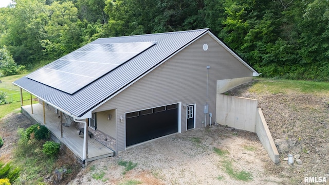 797 State Route 29th Hwy, Sparland, IL 61565 - view of front facade featuring roof mounted solar panels, a metal roof, driveway, and a forest view