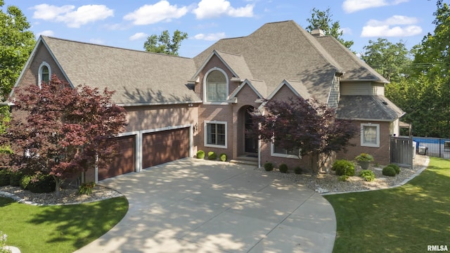 2815 W Windpointe Dr, Peoria, IL 61614 - view of front of home featuring concrete driveway, brick siding, an attached garage, and a shingled roof
