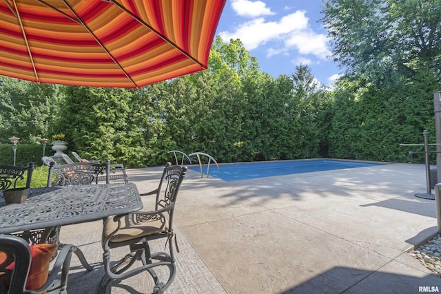 2815 W Windpointe Dr, Peoria, IL 61614 - view of patio / terrace featuring outdoor dining space and an outdoor pool