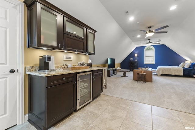 2815 W Windpointe Dr, Peoria, IL 61614 - kitchen featuring beverage cooler, light colored carpet, dark brown cabinetry, a ceiling fan, and lofted ceiling