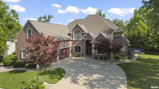 2815 W Windpointe Dr, Peoria, IL 61614 - view of front of house with concrete driveway, a front lawn, brick siding, and an attached garage