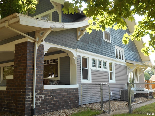 994 N Crafford St, Bushnell, IL 61422 - view of side of home with a central AC unit and a gate