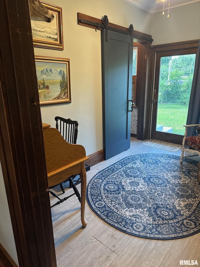 994 N Crafford St, Bushnell, IL 61422 - interior space featuring wood finished floors, a barn door, and ornamental molding