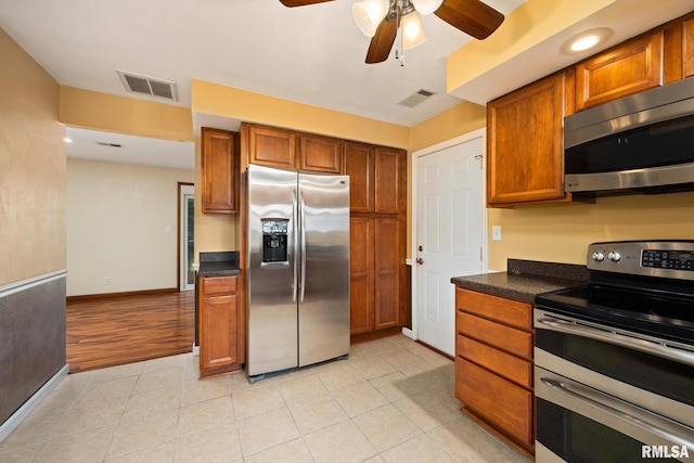 524 Crestview Dr, Metamora, IL 61548 - kitchen with appliances with stainless steel finishes, ceiling fan, brown cabinets, and light tile patterned flooring