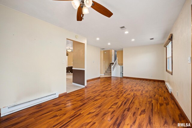 524 Crestview Dr, Metamora, IL 61548 - spare room featuring a baseboard heating unit, a baseboard radiator, wood finished floors, a ceiling fan, and recessed lighting