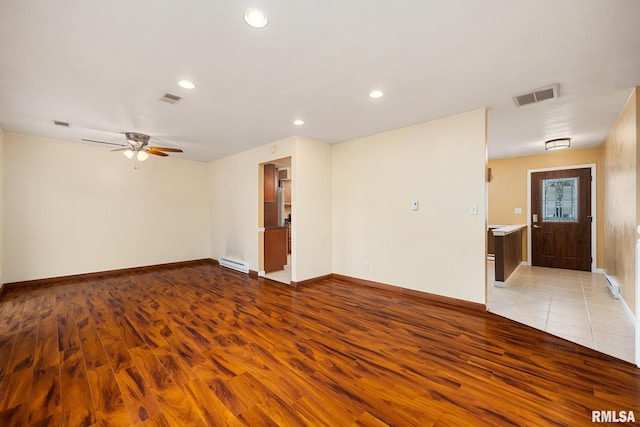 524 Crestview Dr, Metamora, IL 61548 - unfurnished room featuring light wood-type flooring, a baseboard radiator, a ceiling fan, and recessed lighting