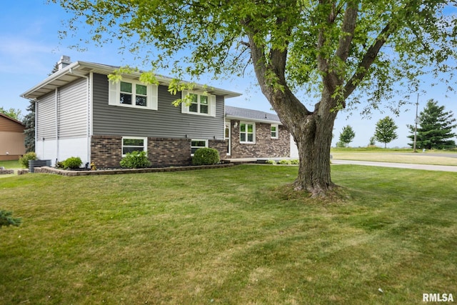 524 Crestview Dr, Metamora, IL 61548 - split level home featuring a front yard, brick siding, and a chimney