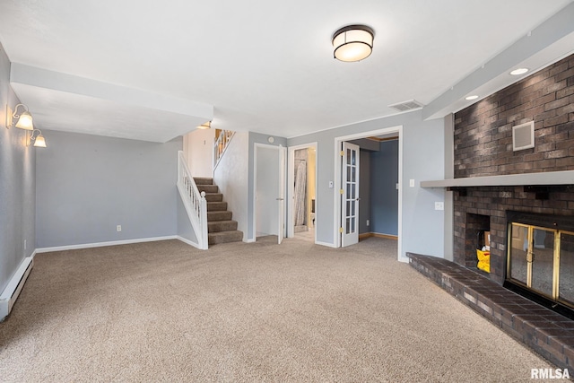 524 Crestview Dr, Metamora, IL 61548 - unfurnished living room featuring carpet flooring, stairs, and a brick fireplace