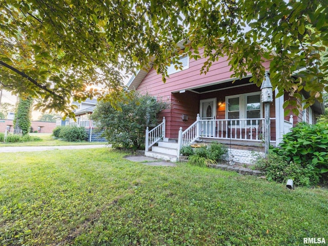 335 Prince St, Pekin, IL 61554 - view of front of home with a front lawn and covered porch