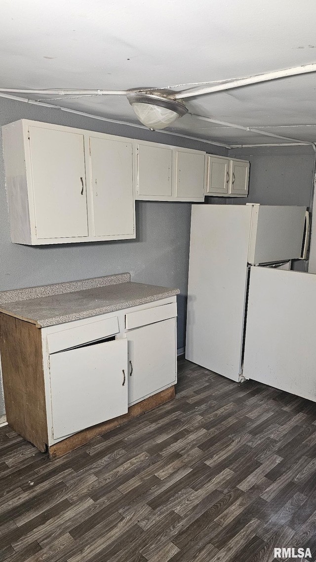 1509 S Western Ave, Peoria, IL 61605 - basement featuring dark wood finished floors and freestanding refrigerator