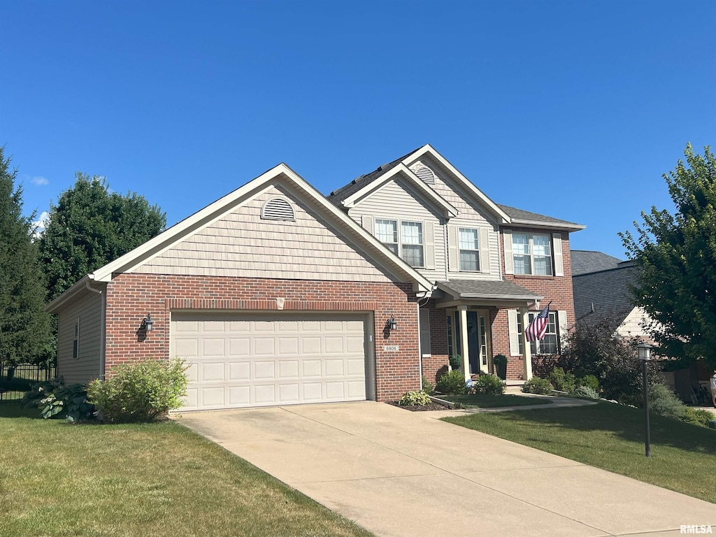 6806 N Ironwood Dr, Edwards, IL 61528 - craftsman house featuring concrete driveway, a front yard, brick siding, and an attached garage