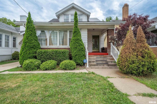 1922 W Rohmann Ave, West Peoria, IL 61604 - bungalow-style house with brick siding, covered porch, and a front lawn