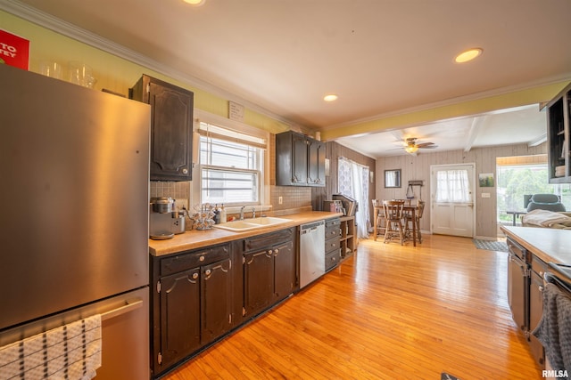 1922 W Rohmann Ave, West Peoria, IL 61604 - kitchen featuring appliances with stainless steel finishes, light wood-style flooring, dark brown cabinets, light countertops, and beam ceiling