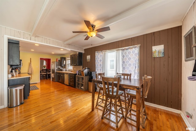 1922 W Rohmann Ave, West Peoria, IL 61604 - dining area with a ceiling fan, crown molding, light wood-type flooring, beamed ceiling, and wooden walls