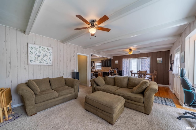 1922 W Rohmann Ave, West Peoria, IL 61604 - living area with beamed ceiling, a ceiling fan, wood walls, and light wood-style floors
