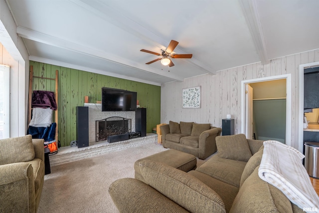 1922 W Rohmann Ave, West Peoria, IL 61604 - living room featuring beam ceiling, ceiling fan, carpet flooring, a fireplace, and wood walls