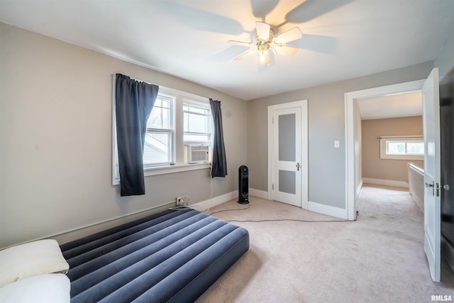1922 W Rohmann Ave, West Peoria, IL 61604 - bedroom with cooling unit, light carpet, and ceiling fan