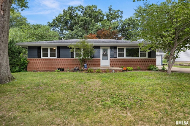 3819 N Saymore Ln, Peoria, IL 61615 - view of front of house with a front yard, brick siding, a garage, and concrete driveway