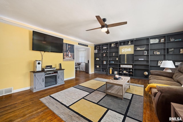 3819 N Saymore Ln, Peoria, IL 61615 - living room featuring a ceiling fan, wood finished floors, and built in shelves