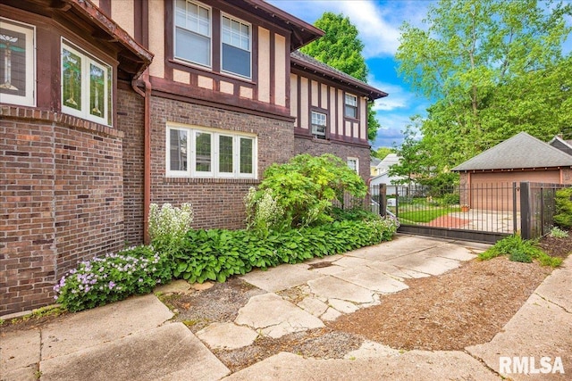 1027 N Maplewood Ave, Peoria, IL 61606 - view of side of home with a gate and brick siding