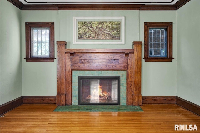 1027 N Maplewood Ave, Peoria, IL 61606 - detailed view of wood finished floors, crown molding, and a fireplace with flush hearth
